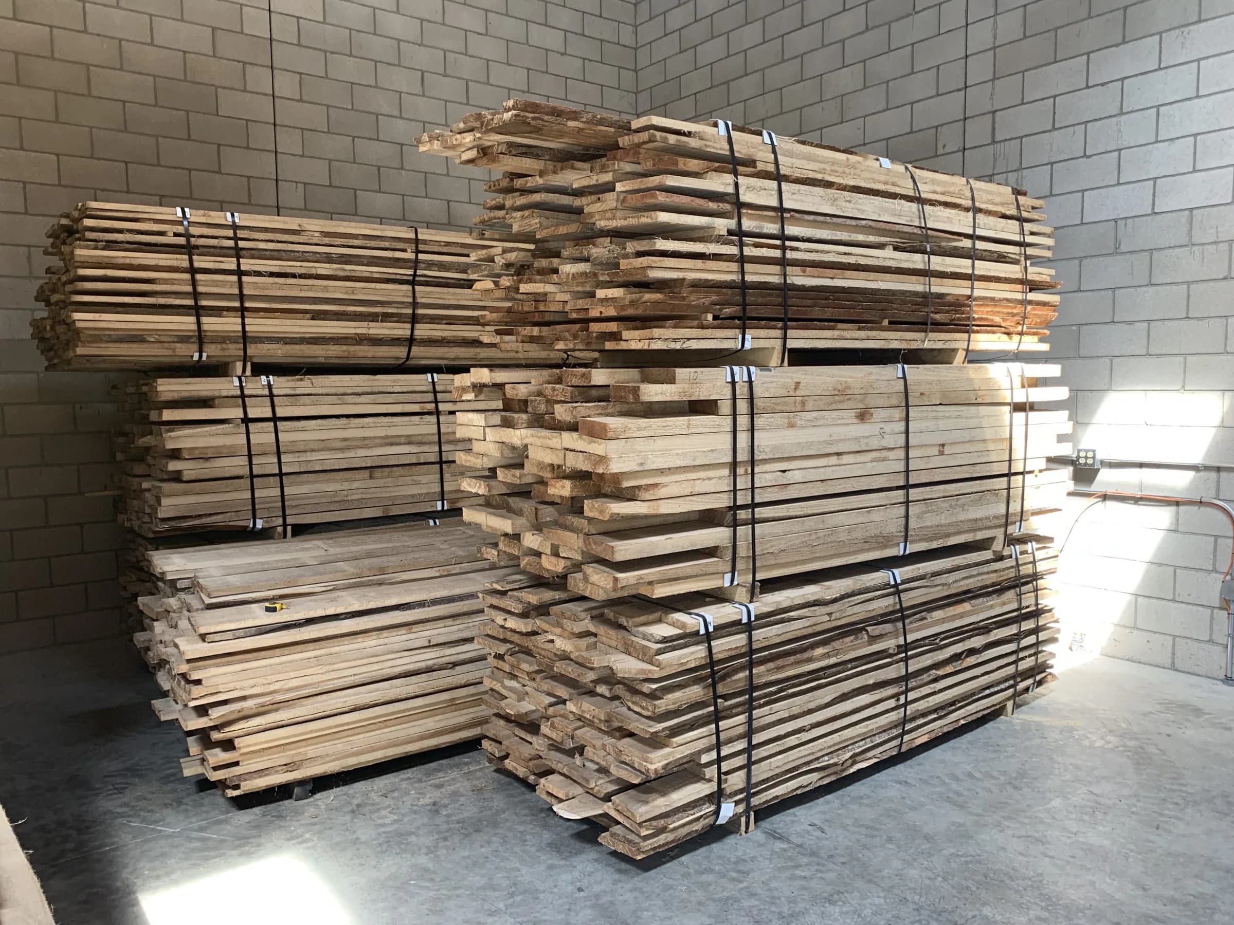 Stacks of kiln-dried paulownia lumber banded and ready in a warehouse