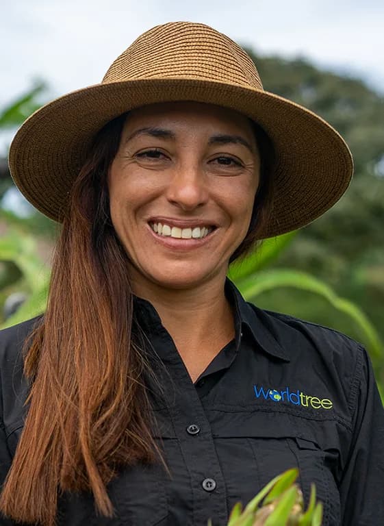 Mariana Alfaro of the World Tree field team beside a paulownia trunk
